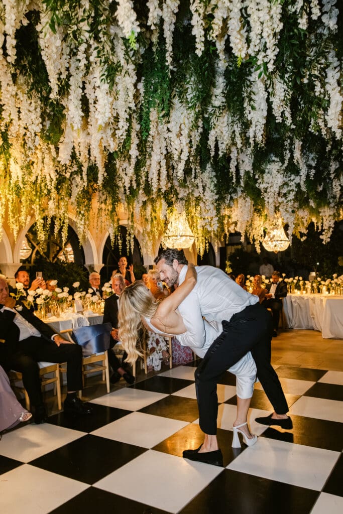 Romantic first dance under floral ceiling at luxury wedding in France at Airelles La Messardière.
