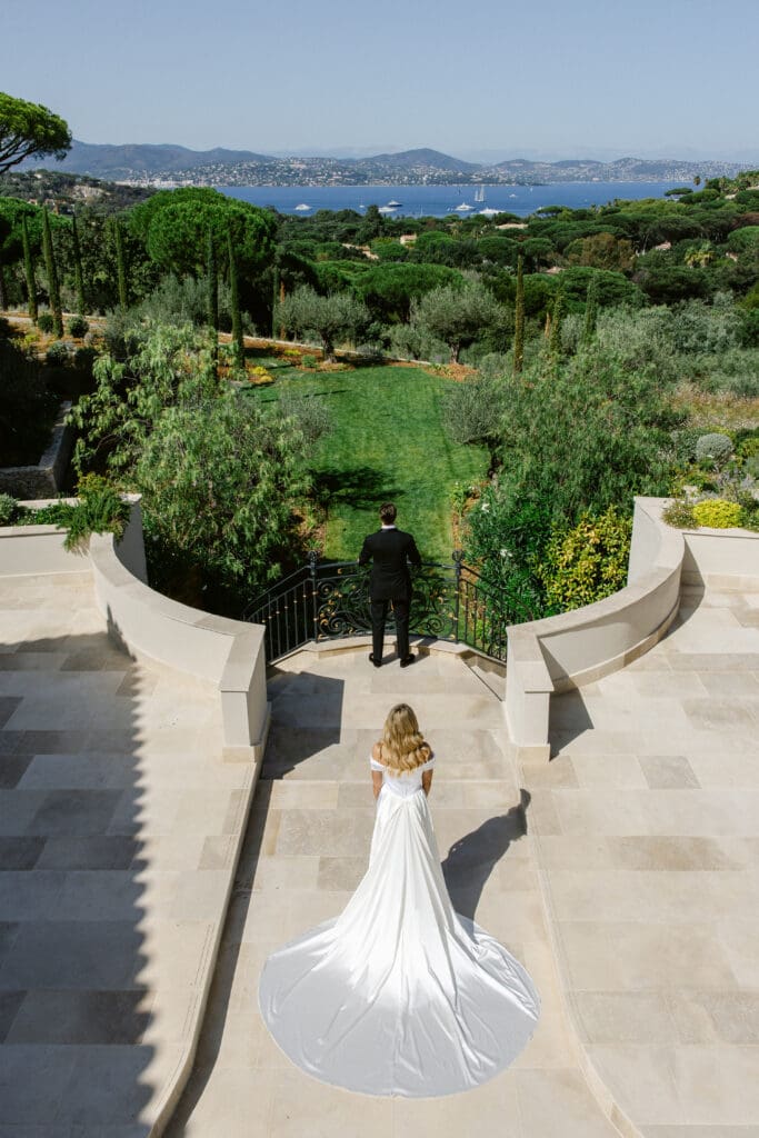 Emotional first look in the gardens of Airelles during luxury destination wedding in Saint-Tropez.