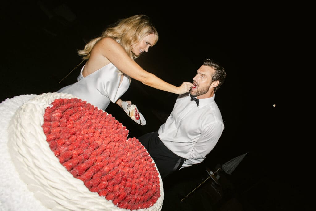 Candid moment during cake tasting at luxury wedding in Airelles Saint-Tropez.