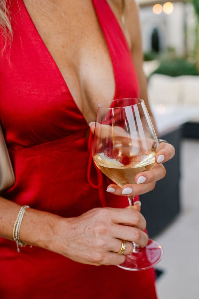 Elegant guest enjoying cocktail hour at destination wedding in Saint-Tropez at Airelles.