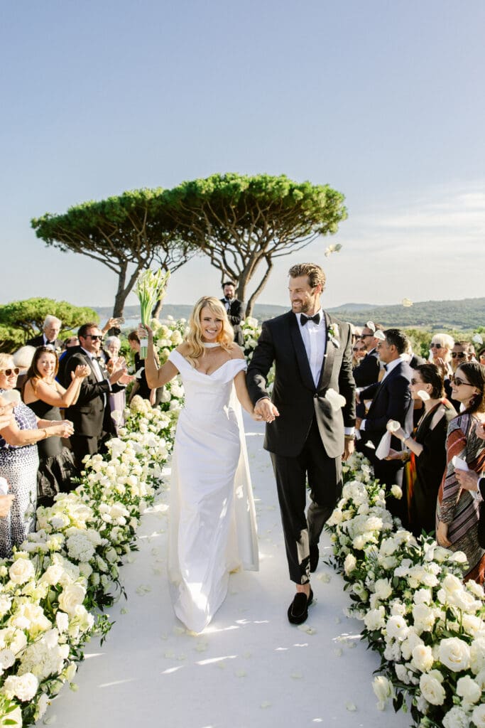 Joyful exit of the couple after luxury garden ceremony in Saint-Tropez, France.