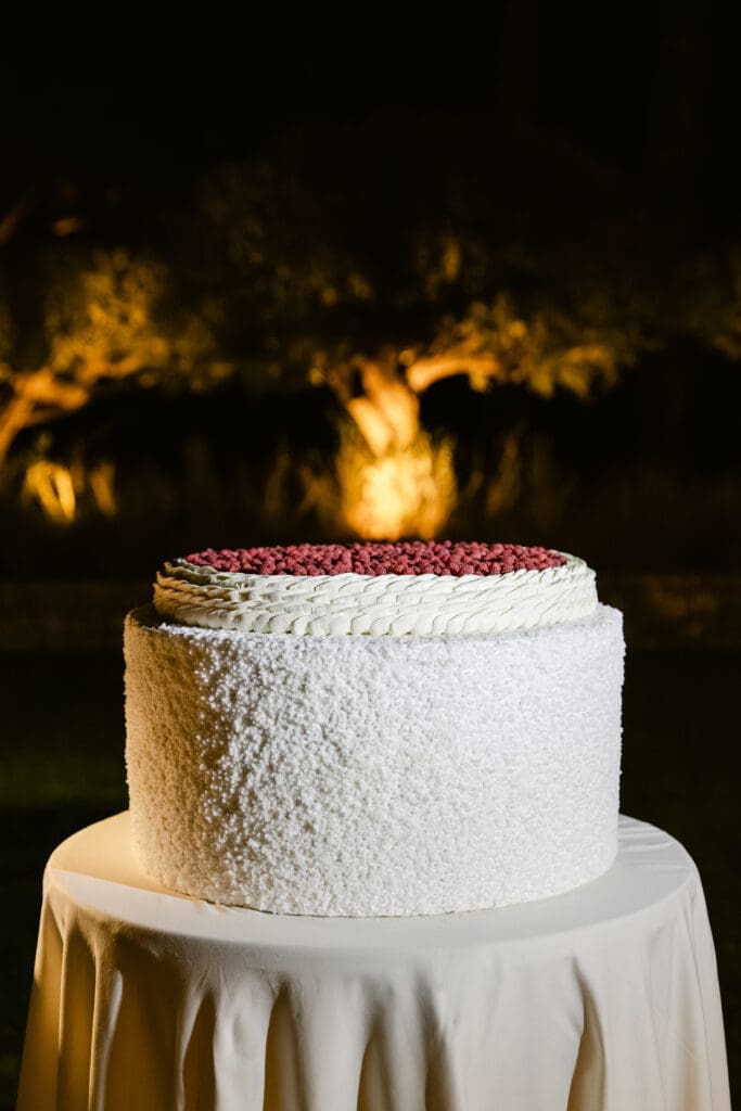 Luxury wedding cake at Airelles Saint-Tropez with raspberry topping, perfect for a chic reception.