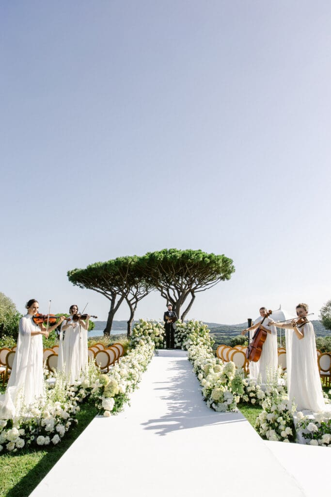 Live string quartet performance during outdoor wedding ceremony at Airelles in Saint-Tropez.