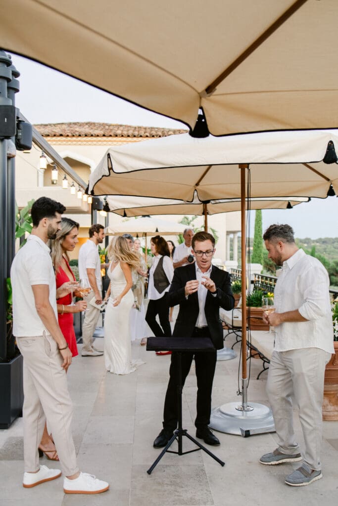 Luxury wedding welcome dinner at Airelles Saint-Tropez with magician and elegant guests.